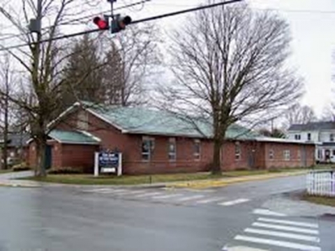 One-level, brick church building of Our Lady of the Valley Roman Catholic Church on the corner of Main St & Wells Ave., in Middleburgh, NY